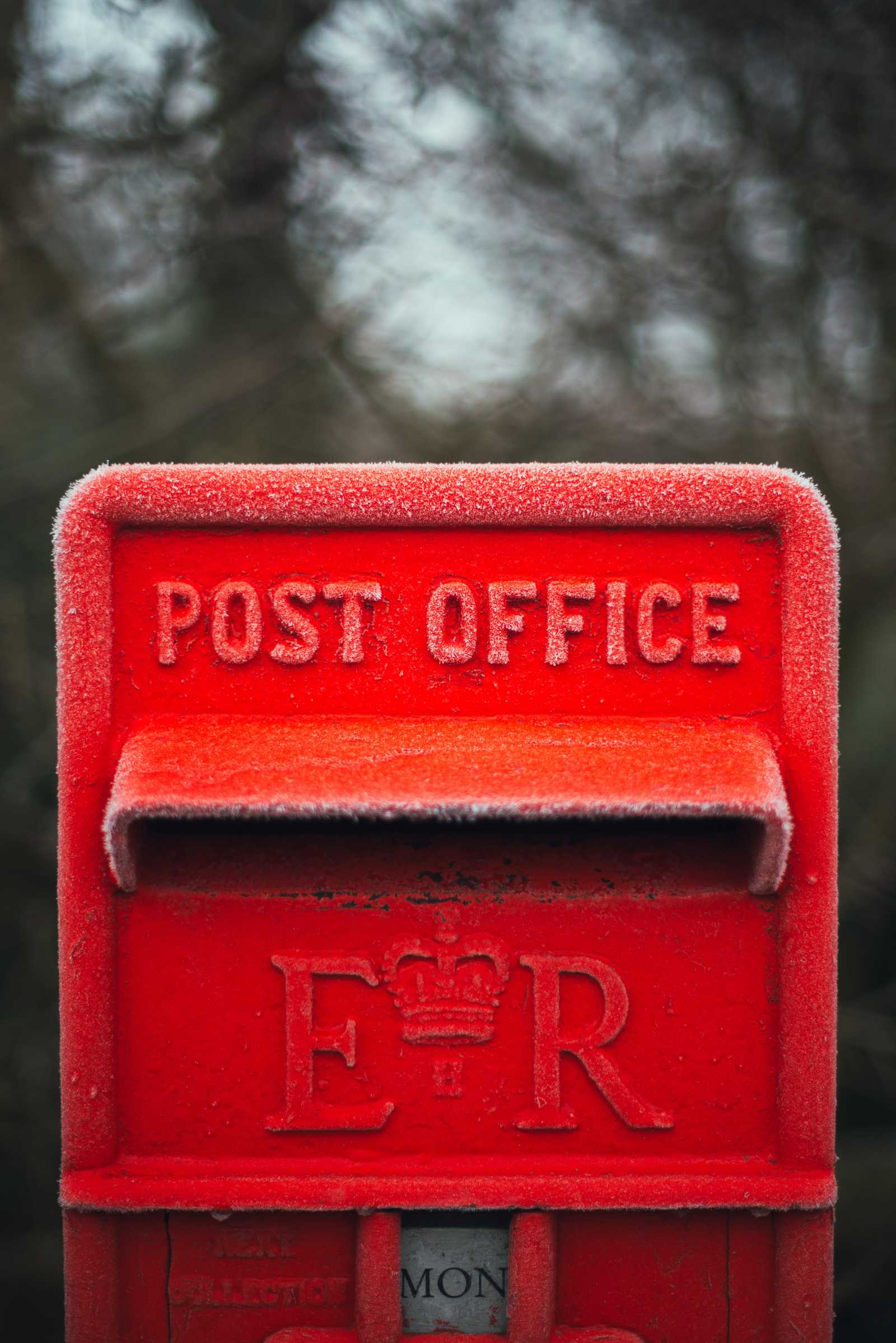 A post box with frost around its edges